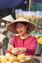 Woman selling fruits in a street market of HoÃÂ n KiÃ¡ÂºÂ¿m, the old quarter of Hanoi Royalty Free Stock Photo